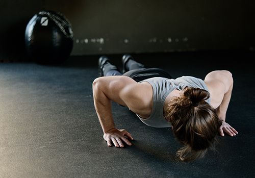 A man is demonstrating the proper exercise technique for push-ups.