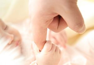 baby holding finger