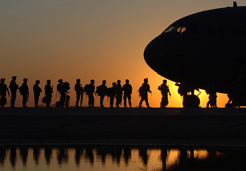 Soldiers board a plane. We honor them on Veterans Day.