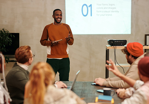 A man gives a speech at an office.