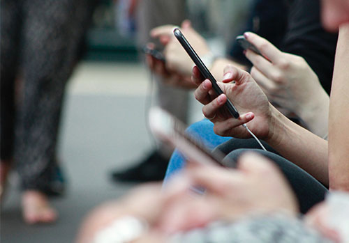 hand holding smartphone on crowded public transport