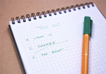 A to do list of tasks written in pen on a desk