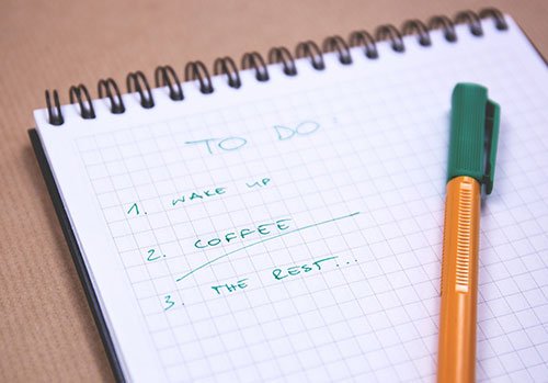 A to do list of tasks written in pen on a desk