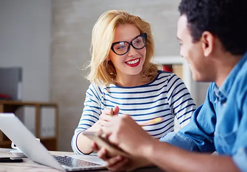 An female insurance professional sits down with a client.