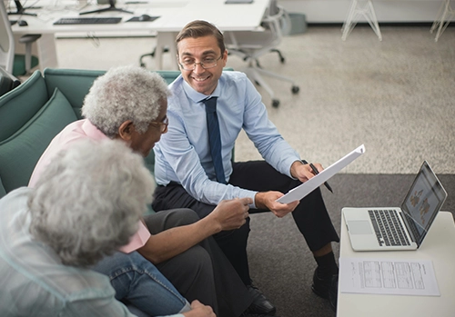 life and health insurance agent showing documents to seniors